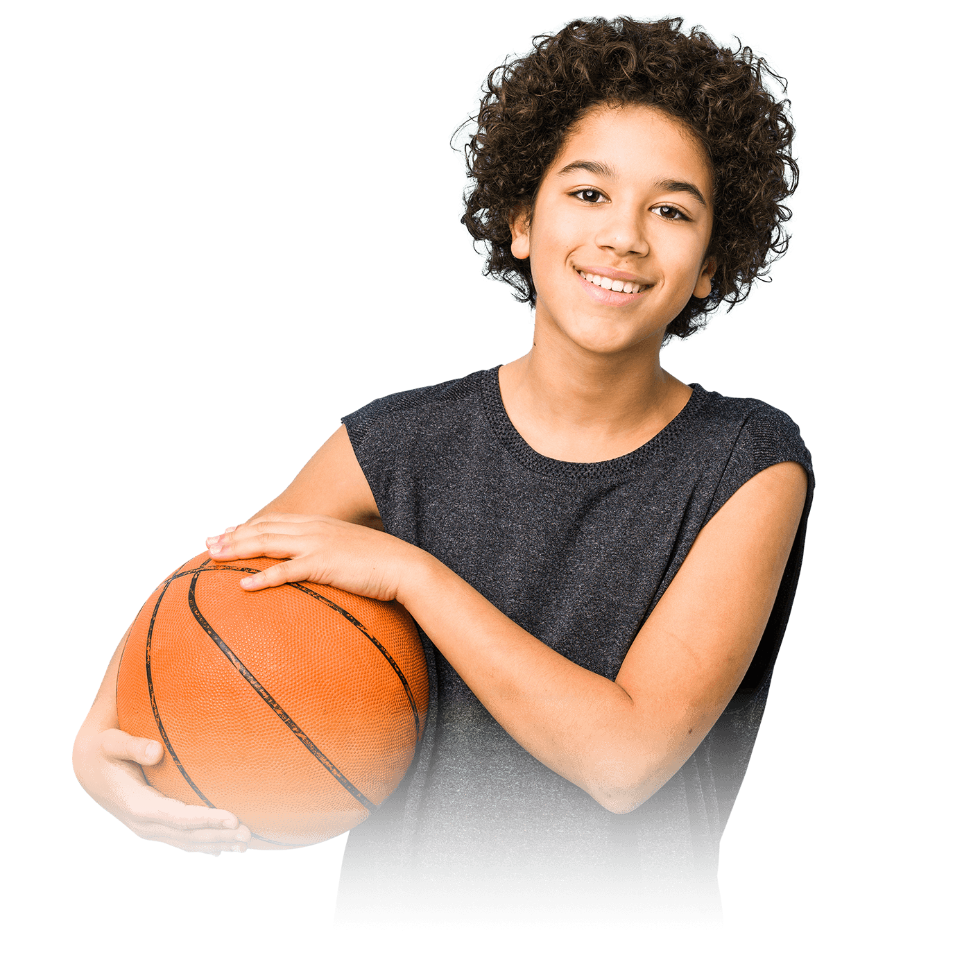 A young boy in a gray t-shirt holding a basketball.
